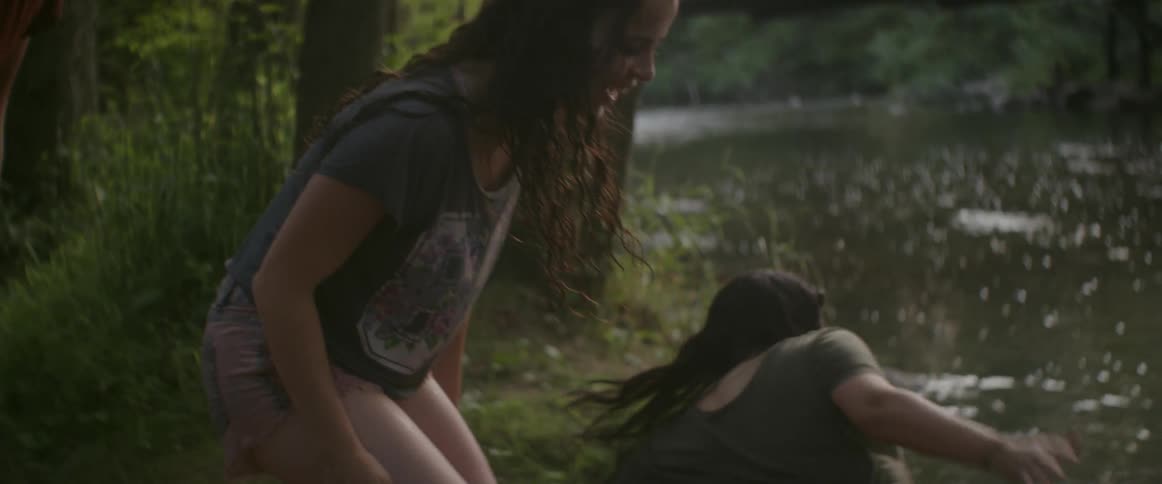 Women smile and enter a river
