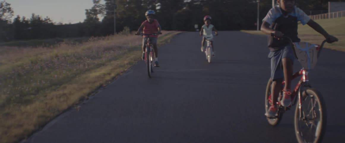 Children ride bicycles in a rural area