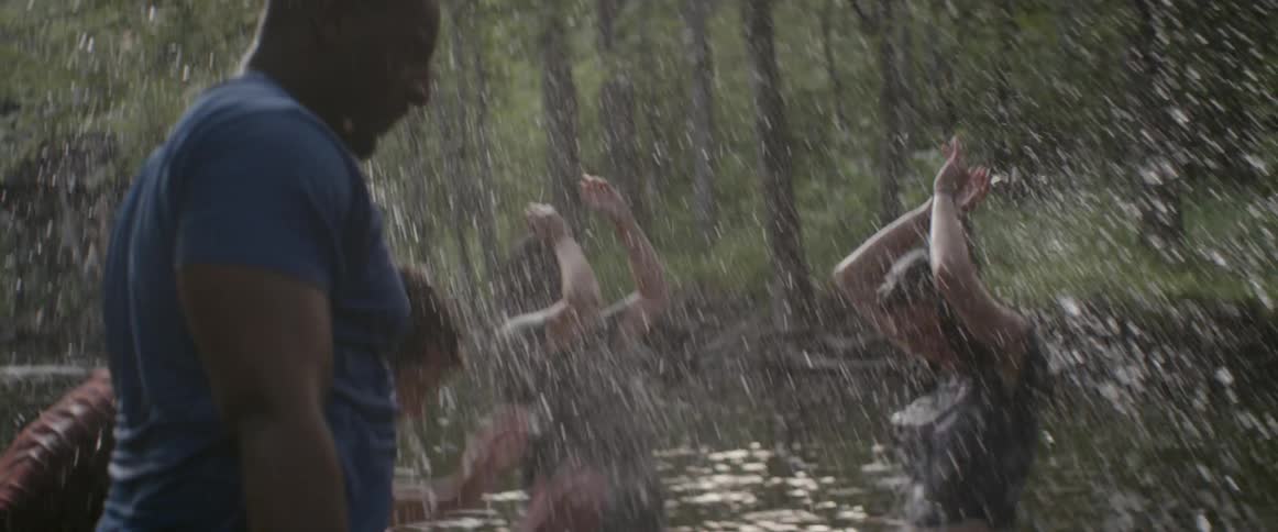 People play and splash in river water