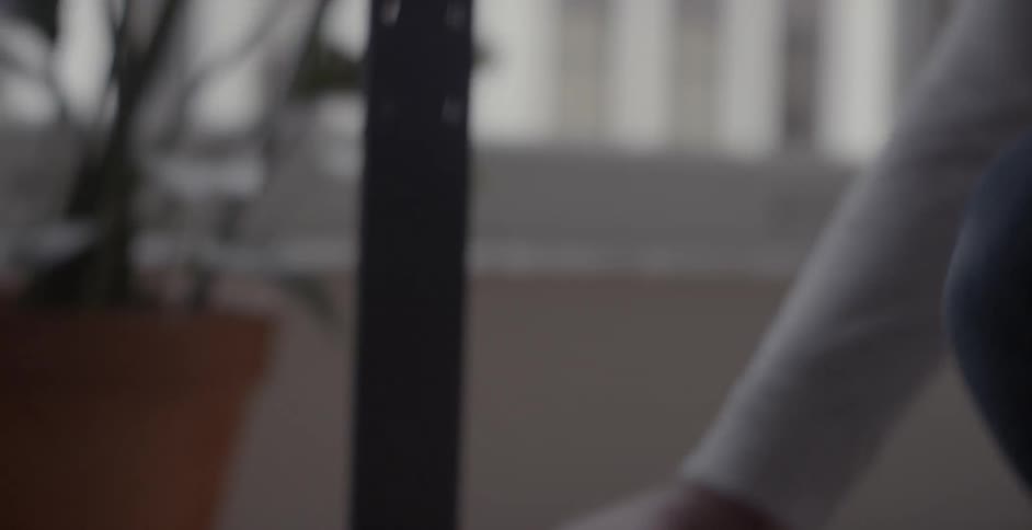 A bearded man tightens a screw