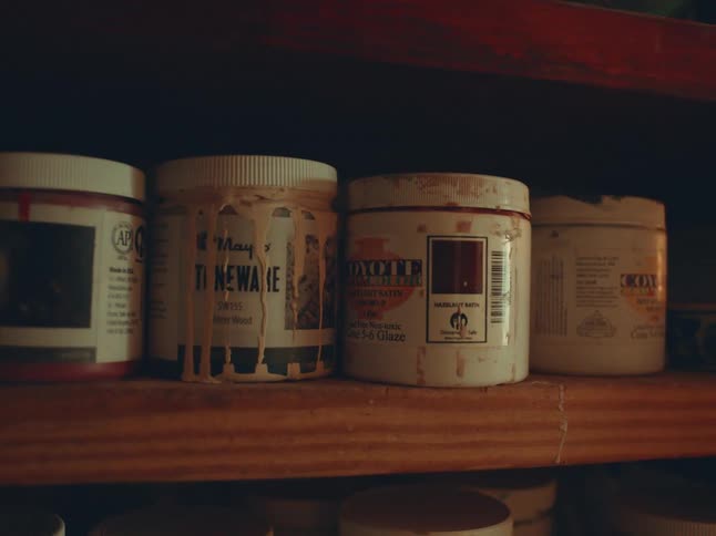 Various pots on a wooden shelf