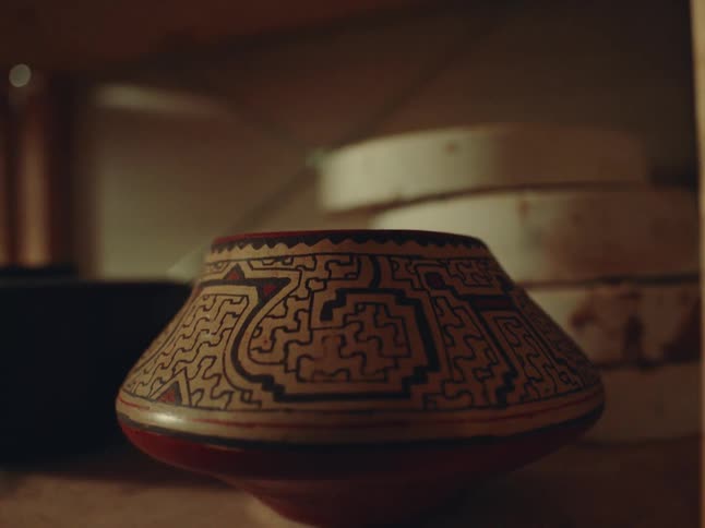 A vase with a design carved into it