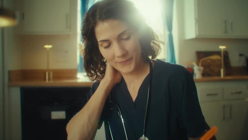 Nurse sitting at desk thoughtfully