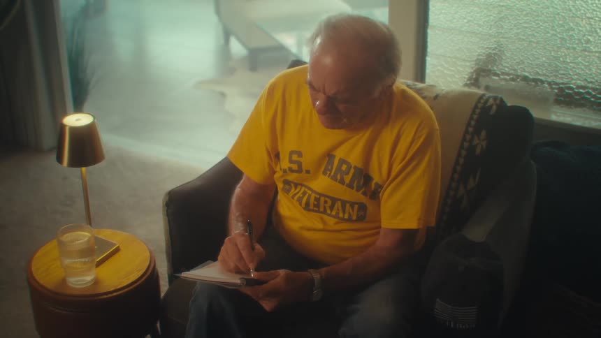A man is writing notes in his notebook