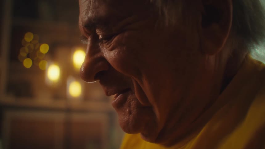 Elderly man writing in a notebook