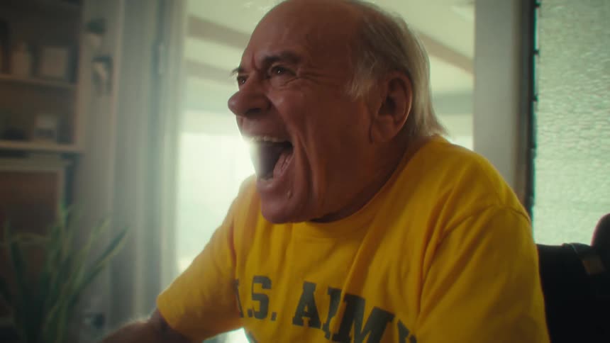 Elderly man sitting vibrating happily