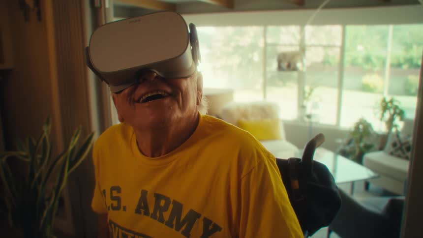 Elderly man smiles while wearing a vr headset indoors