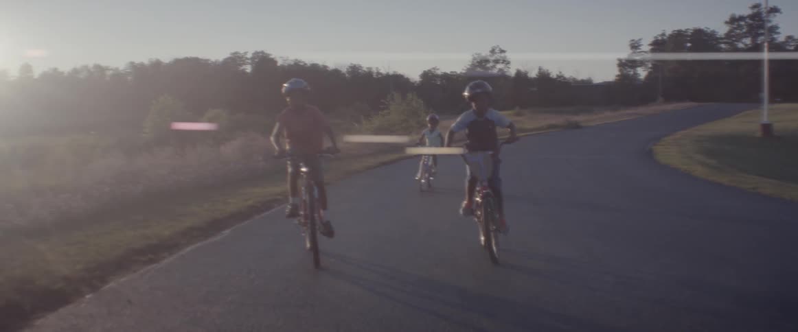 Children ride their bikes down the road
