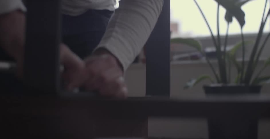 A man assembles a piece of furniture