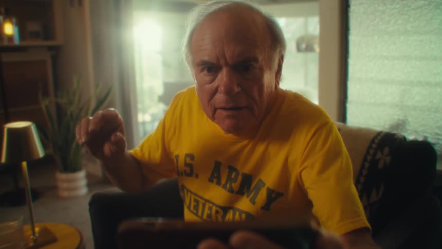 The man gets angry at something he is watching on his phone