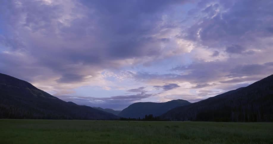 A long field leads to a mountain range