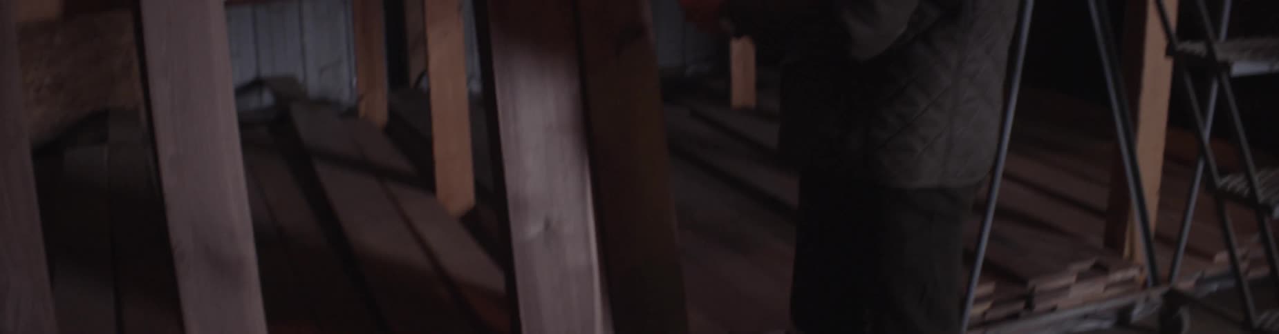 A man measures a piece of lumber