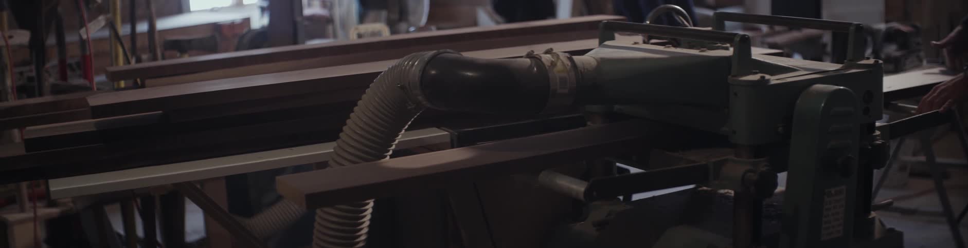 A piece of lumber is run through machinery