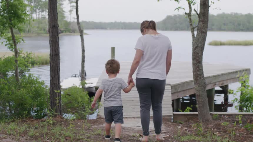 A mother walks with her son on the pier