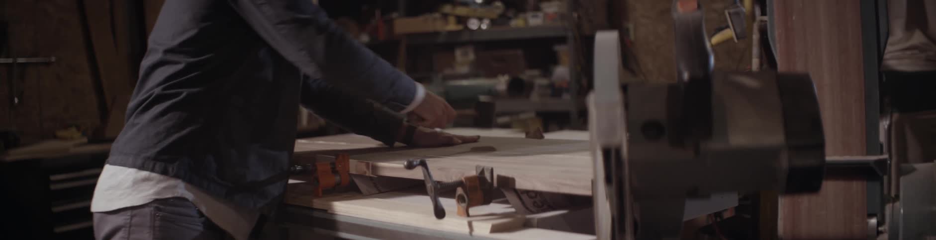 A man bangs wood with a mallet