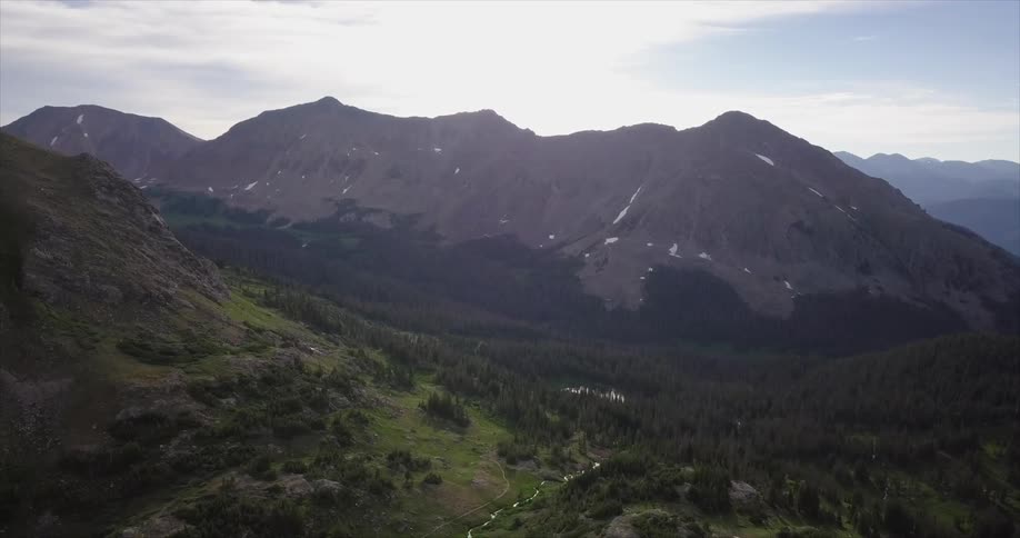 A mountain surrounded by forests on a clear day