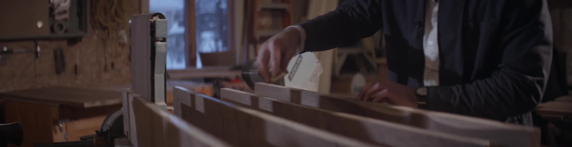 A man adjusts a guide on a saw table