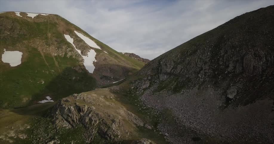 The mountains have some snow on the top