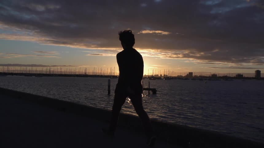 People walking at sunset near the water