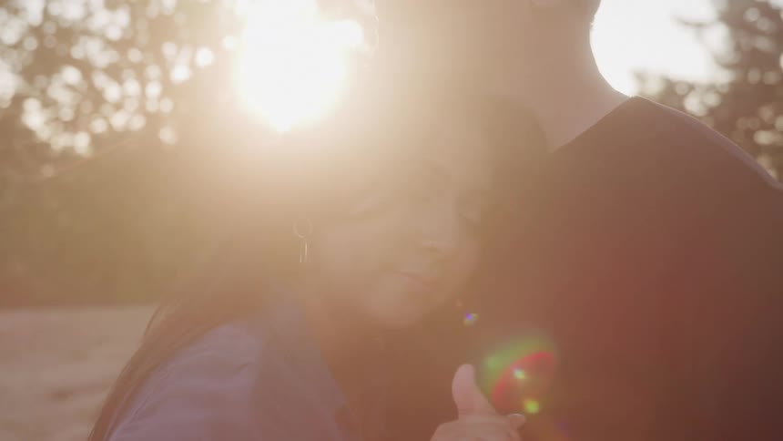 A couple are dancing outside