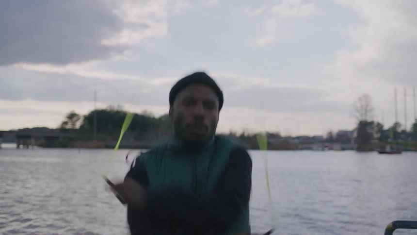 A man is jumping rope by the water