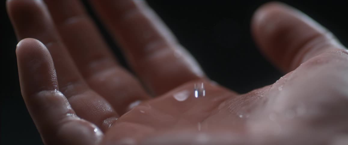 Water dropping on an open palm