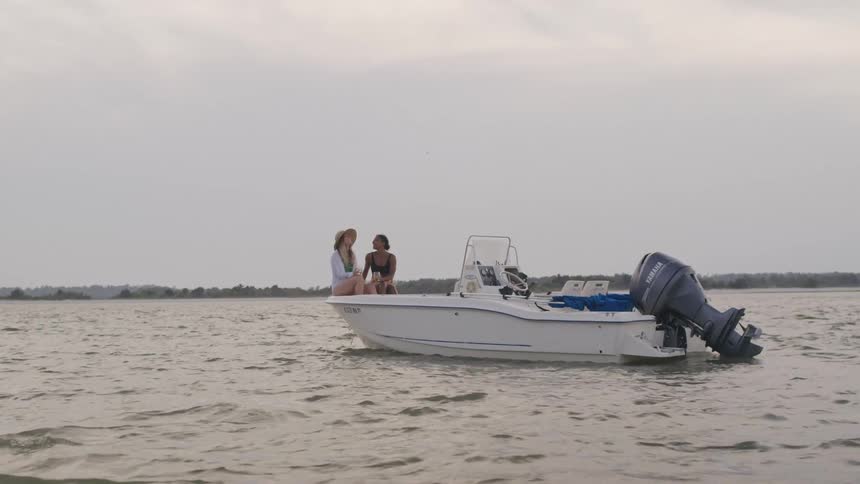 Two friends talking and having fun on a boat