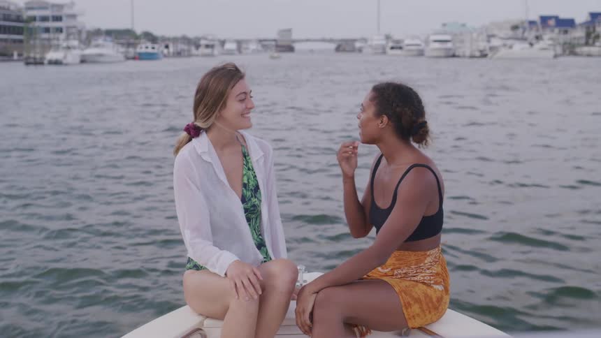 Two friends happily chat and laugh while spending time together