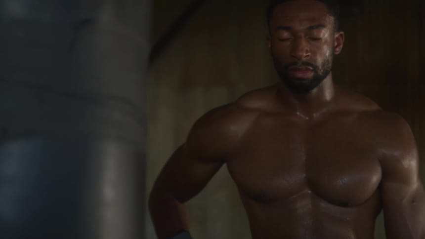 A man breathes heavily after an intense workout