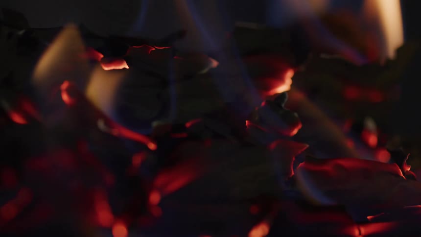 A fire burns through material
