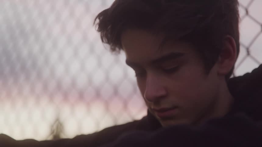 Portrait of a crestfallen teenager outdoors