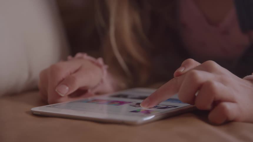 Child fingers interacting with a tablet