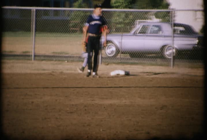 A boy hits a baseball and runs to first base