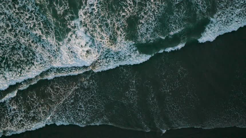 Aerial shot of waves on a beach