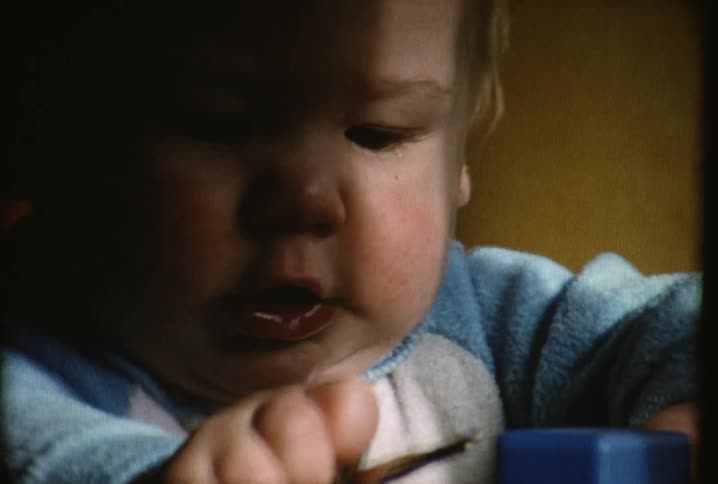An infant plays with keys