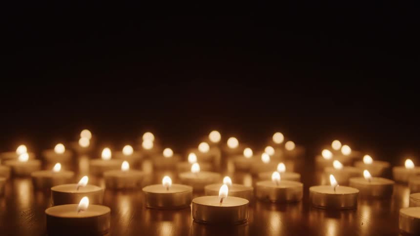 Several small candles lit in a dark room