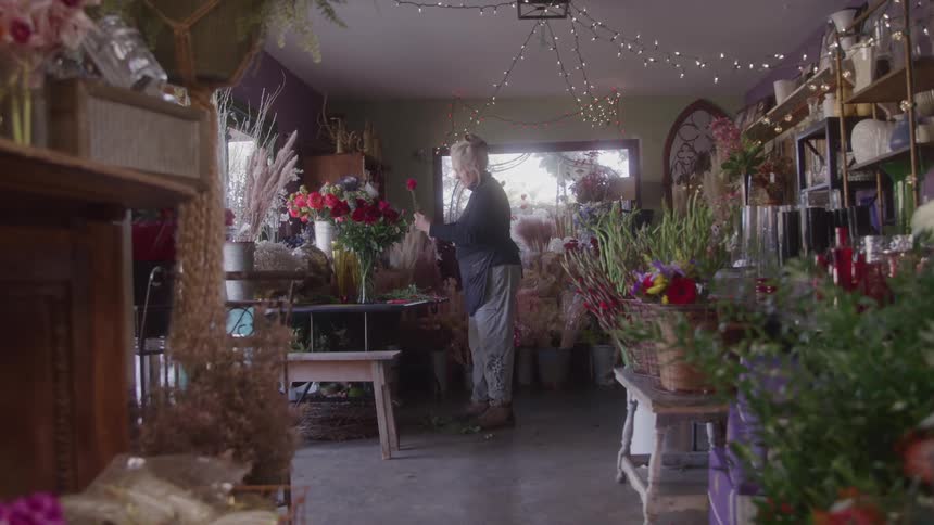 Woman arranging flowers in a flower shop