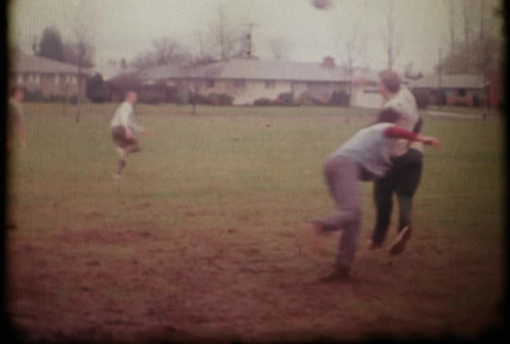 Kids are playing football running and throwing
