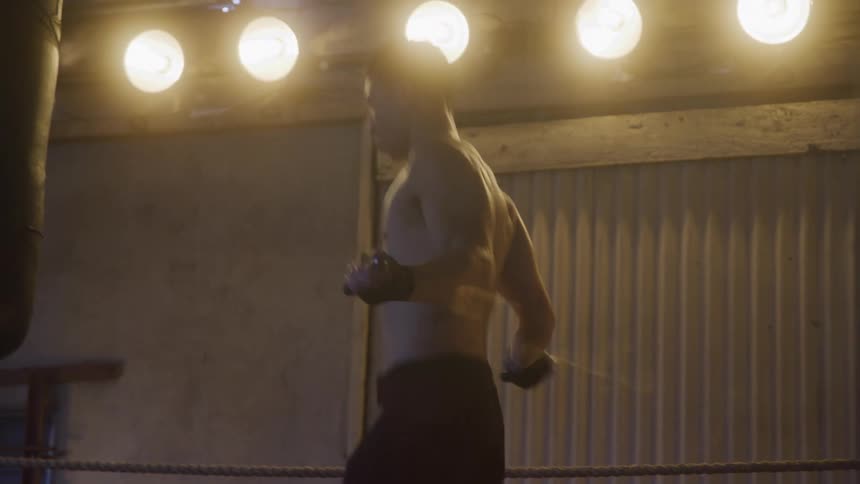 A young man skips rope inside a gym
