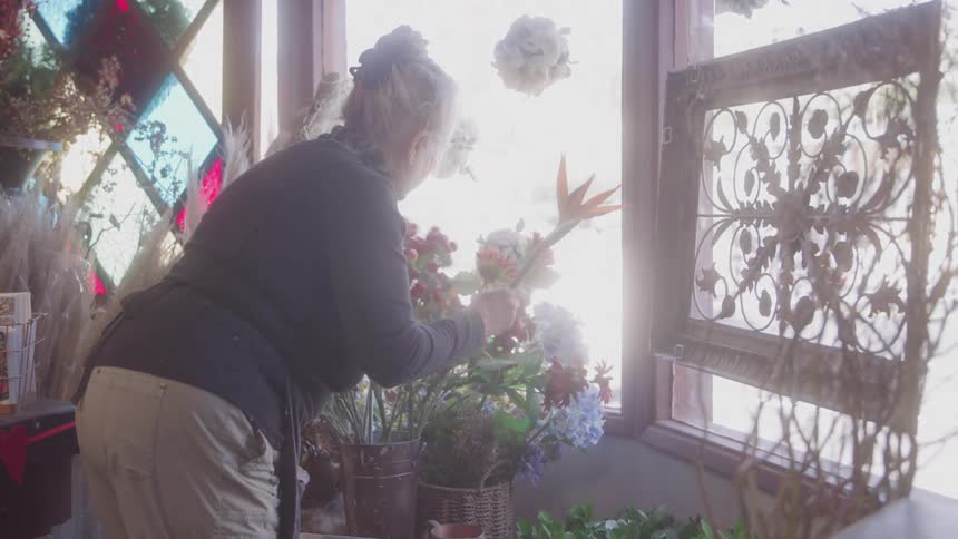 Woman working with flowers in a shop