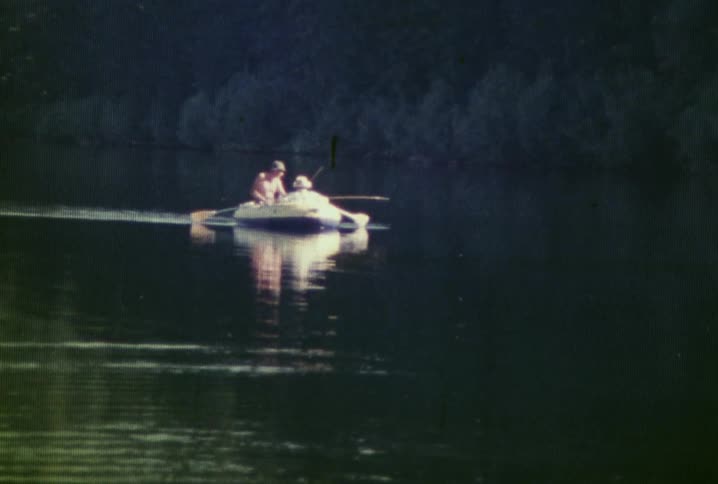 People are rowing in the water ahead