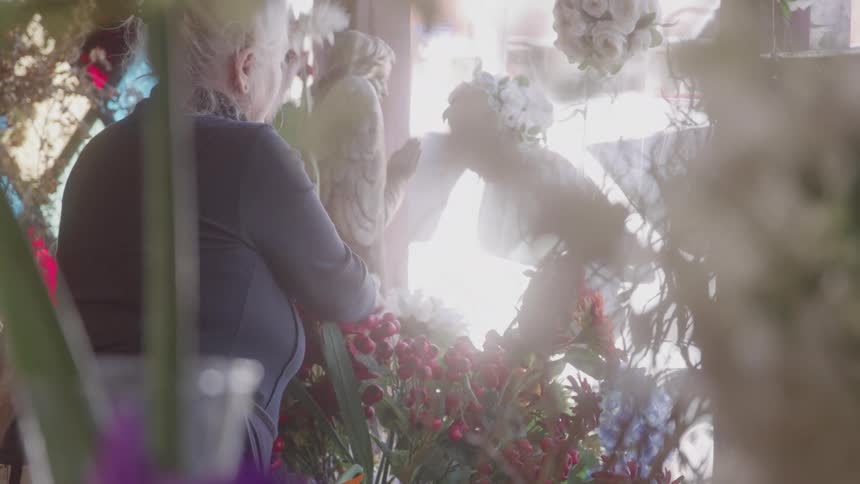 The florist is arranging flowers