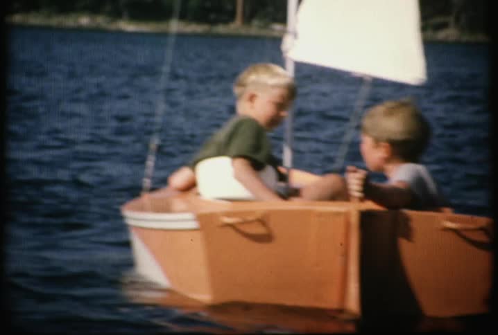 Children are sailing in a small boat