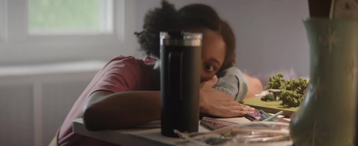 Father waking up his daughter lying in bed