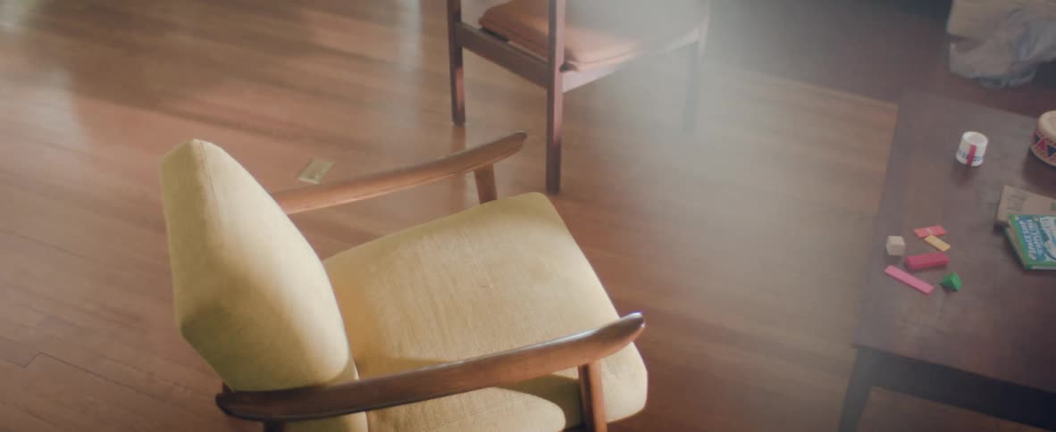 A living room with two arm chair and a table
