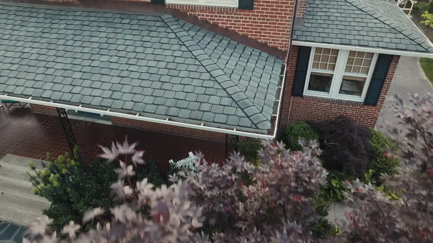 Flying over a tree near a brick house