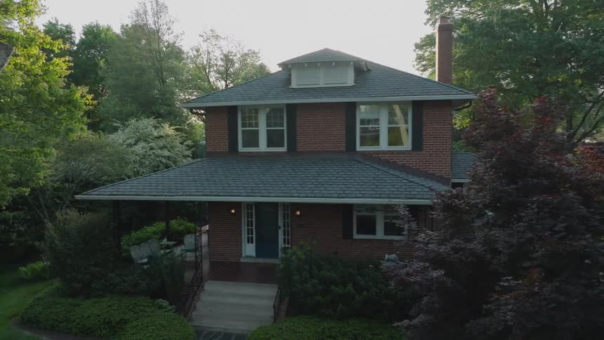 A brick house with a lush lawn