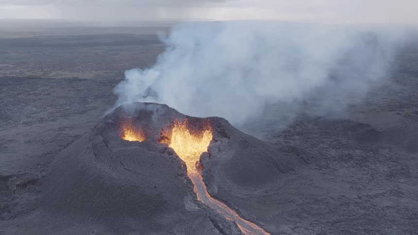 A volcanic eruption occurs in the mountain as smoke and lava erupt from it