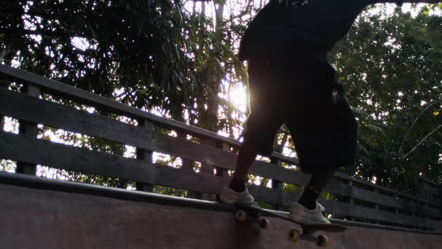 The skateboarder rides the rail on the ramp