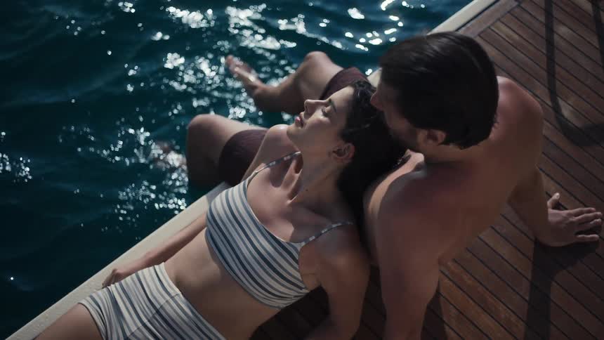 A couple enjoys a warm summer day on a luxury yacht in the mediterranean